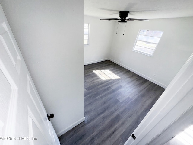 unfurnished room with dark wood-type flooring and ceiling fan