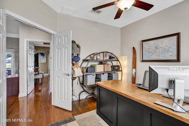 office area featuring visible vents, a ceiling fan, dark wood-style flooring, and baseboards