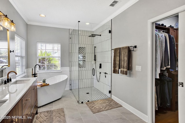 full bath with a shower stall, visible vents, ornamental molding, and a sink