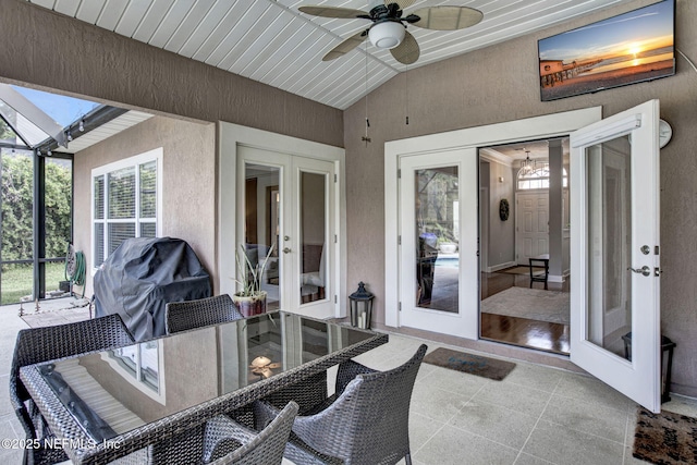 view of patio featuring french doors, a ceiling fan, outdoor dining area, and grilling area