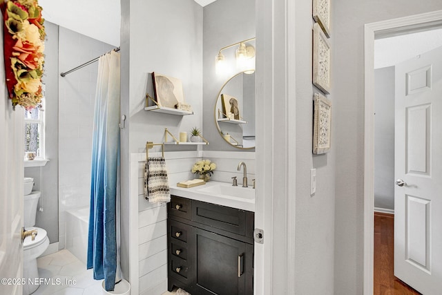bathroom with vanity, shower / bath combo, and toilet