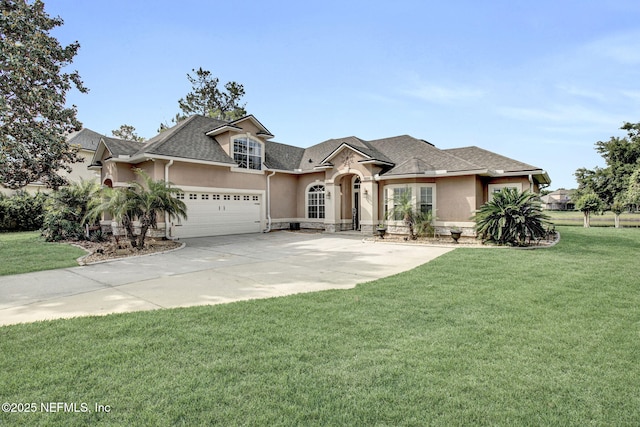french country inspired facade featuring a garage, a front yard, stucco siding, a shingled roof, and driveway