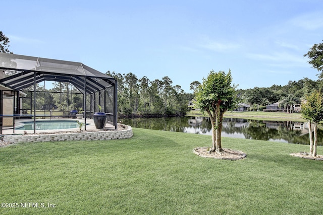 view of yard with a water view, an outdoor pool, and a lanai