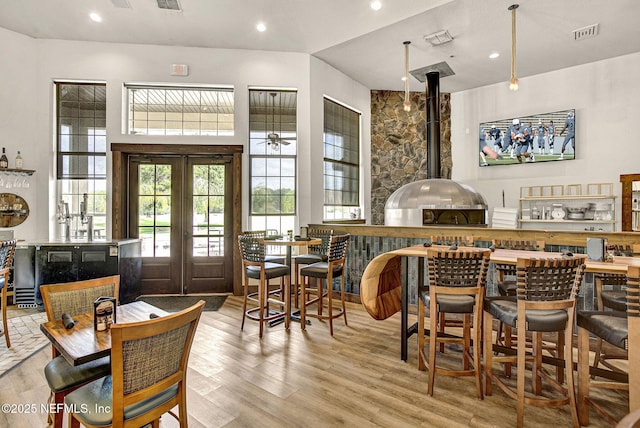 bar with recessed lighting, visible vents, french doors, and wood finished floors