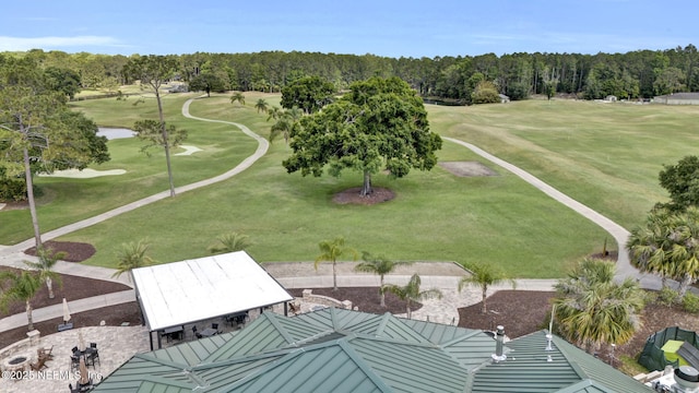 aerial view with a water view, view of golf course, and a forest view
