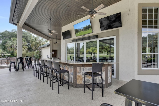 view of patio / terrace with ceiling fan and outdoor wet bar