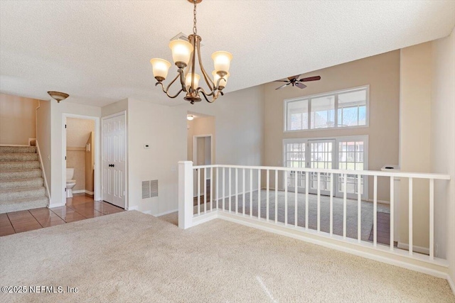 1706 Wood Hill Pl Unit 1706, Jacksonville, FL 32256 - unfurnished room with visible vents, light carpet, a textured ceiling, and light tile patterned floors