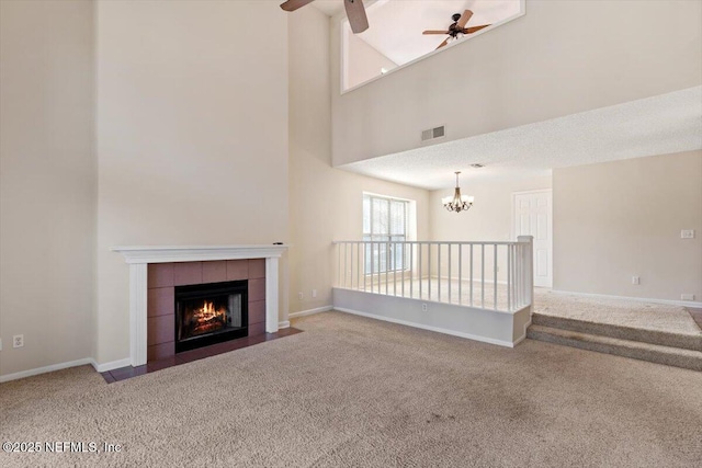 1706 Wood Hill Pl Unit 1706, Jacksonville, FL 32256 - unfurnished living room with carpet flooring, baseboards, visible vents, a tile fireplace, and ceiling fan with notable chandelier