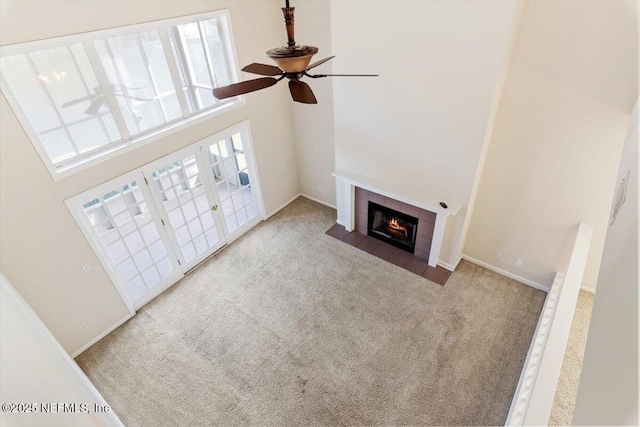 1706 Wood Hill Pl Unit 1706, Jacksonville, FL 32256 - unfurnished living room with a fireplace, light colored carpet, a towering ceiling, and a healthy amount of sunlight