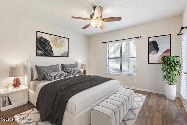1706 Wood Hill Pl Unit 1706, Jacksonville, FL 32256 - bedroom featuring a textured ceiling, dark wood-style floors, a ceiling fan, and baseboards