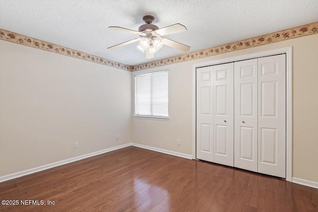 1706 Wood Hill Pl Unit 1706, Jacksonville, FL 32256 - unfurnished bedroom featuring a textured ceiling, wood finished floors, baseboards, and a closet