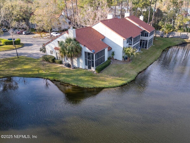 birds eye view of property with a water view