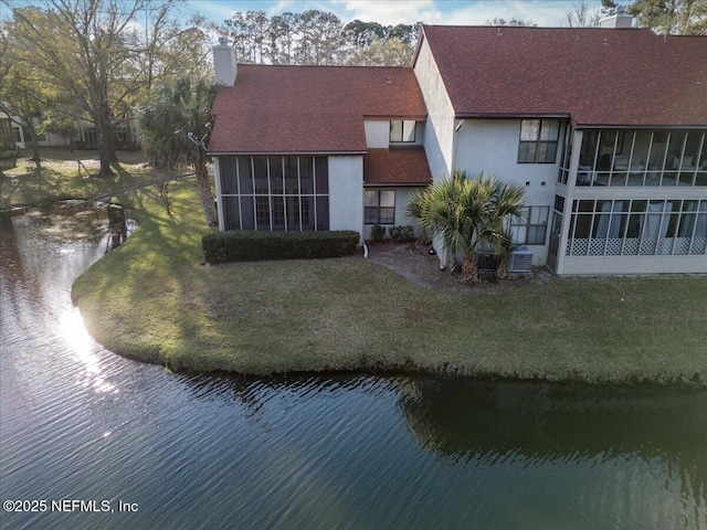 1706 Wood Hill Pl Unit 1706, Jacksonville, FL 32256 - back of house featuring a sunroom, a lawn, a chimney, and a water view