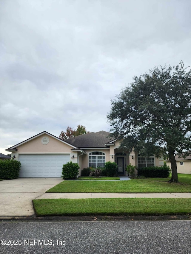 ranch-style home with a garage and a front lawn