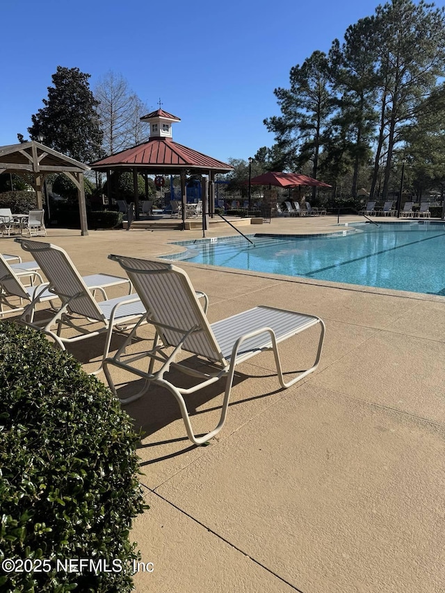 view of swimming pool with a gazebo and a patio