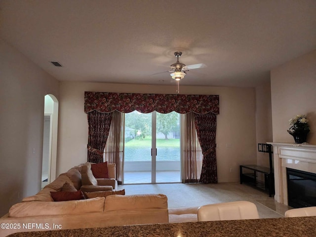 living room with ceiling fan and light colored carpet