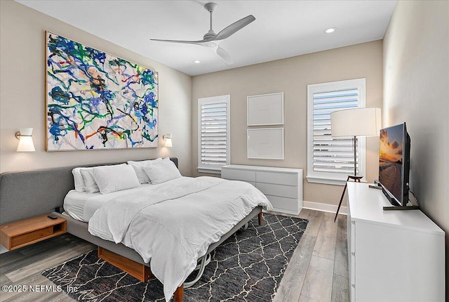 bedroom featuring ceiling fan, recessed lighting, wood finished floors, and baseboards