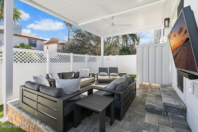 view of patio with a fenced backyard, ceiling fan, and outdoor lounge area