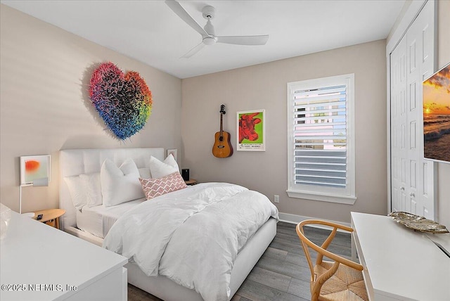 bedroom with a ceiling fan, a closet, baseboards, and wood finished floors