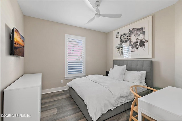 bedroom with dark wood-style flooring, ceiling fan, and baseboards