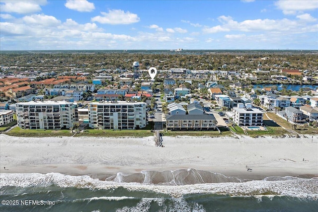 birds eye view of property featuring a water view and a beach view