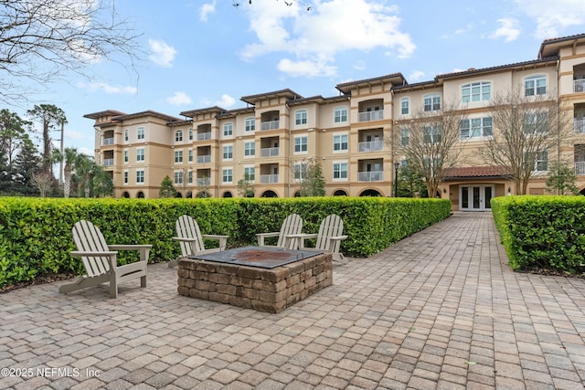 view of community featuring a fire pit and a patio area