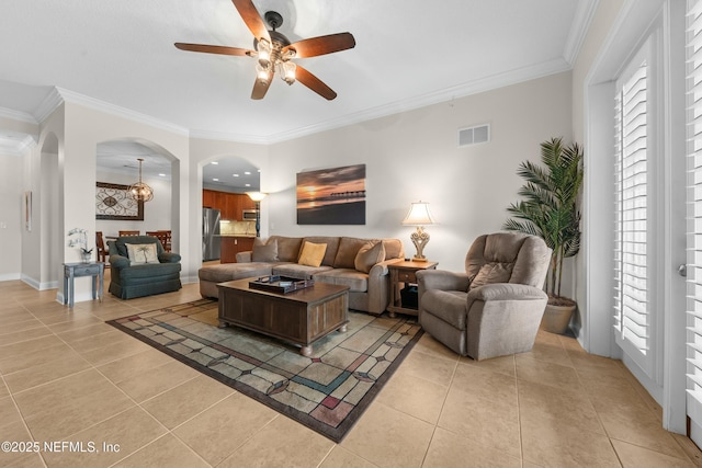 living area with visible vents, arched walkways, and ornamental molding