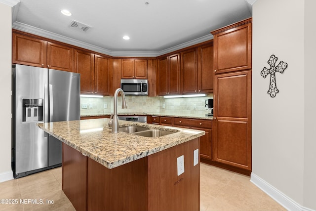 kitchen with a center island with sink, stainless steel appliances, visible vents, backsplash, and light stone countertops