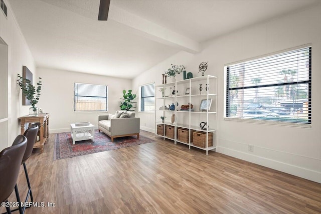 interior space with hardwood / wood-style flooring and vaulted ceiling with beams