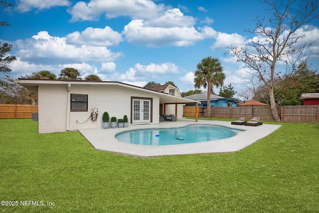 rear view of property with french doors, a yard, a fenced in pool, and a patio