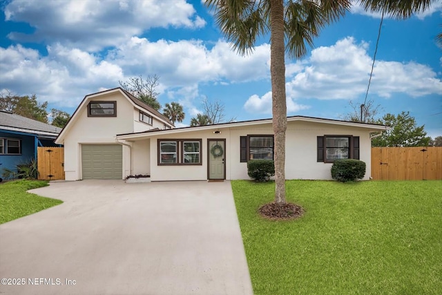 view of front of property featuring a garage and a front lawn