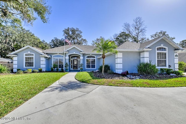 ranch-style house with a front lawn