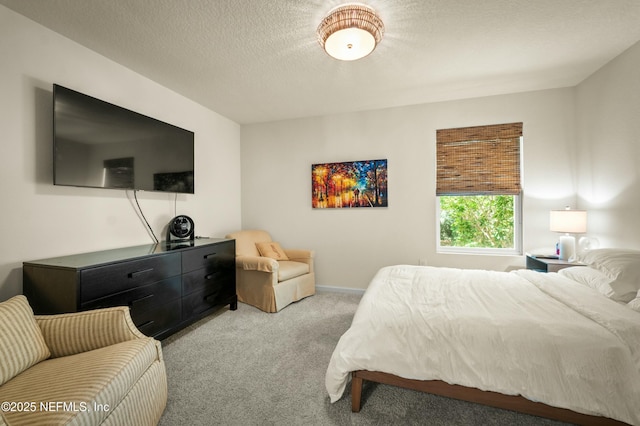 carpeted bedroom featuring a textured ceiling