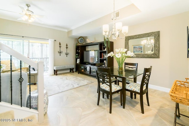 dining space with crown molding and ceiling fan with notable chandelier