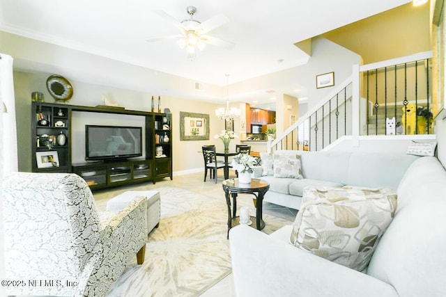 living room with ceiling fan with notable chandelier