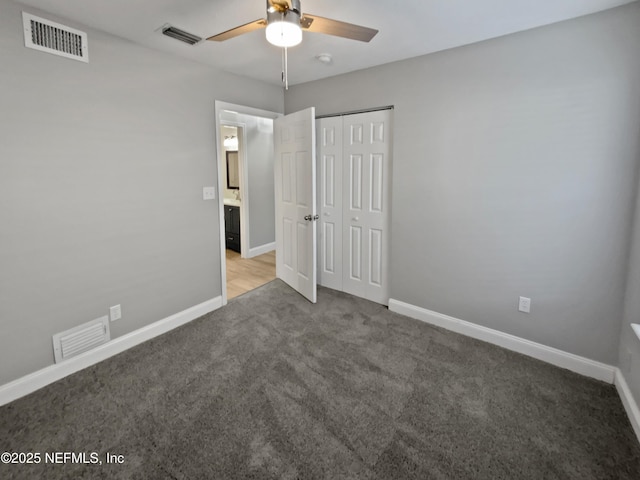 unfurnished bedroom featuring ceiling fan, a closet, and light carpet