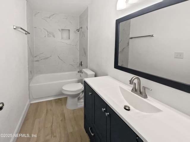 full bathroom featuring hardwood / wood-style flooring, vanity, toilet, and tiled shower / bath combo