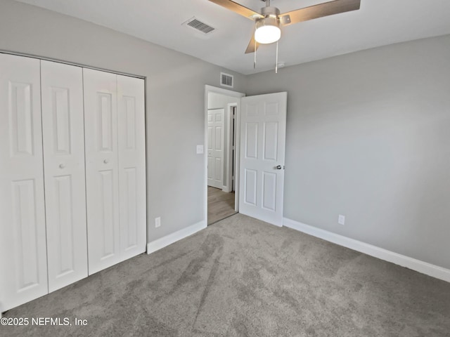 unfurnished bedroom featuring ceiling fan, a closet, and light carpet