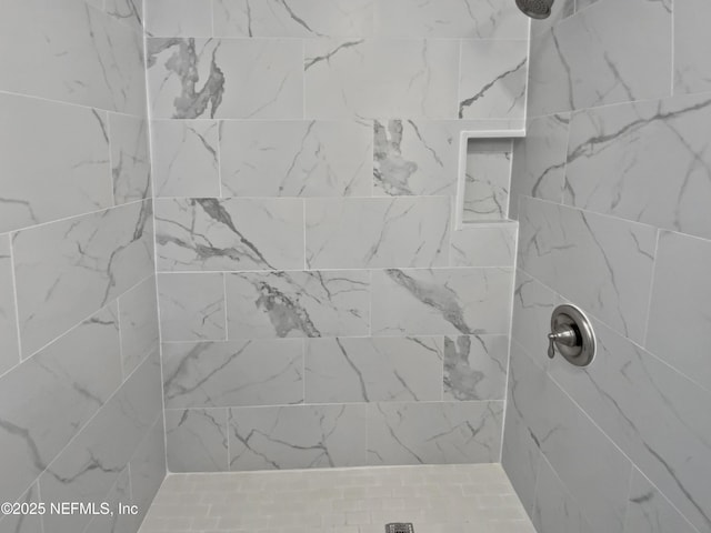 bathroom with tiled shower