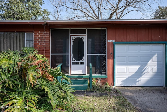 view of exterior entry with a garage