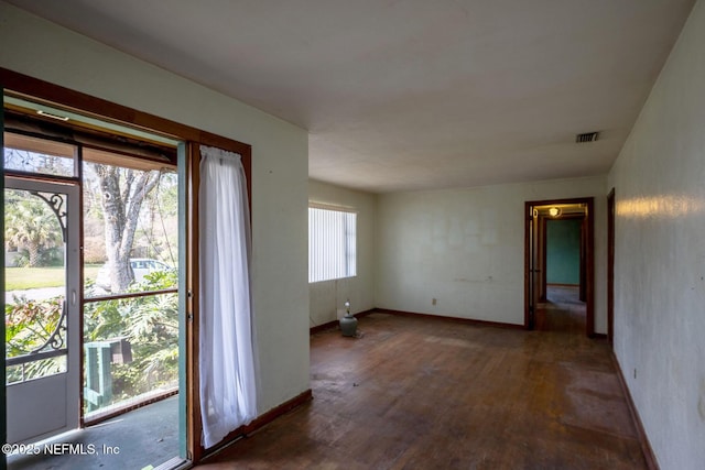 spare room featuring dark hardwood / wood-style flooring