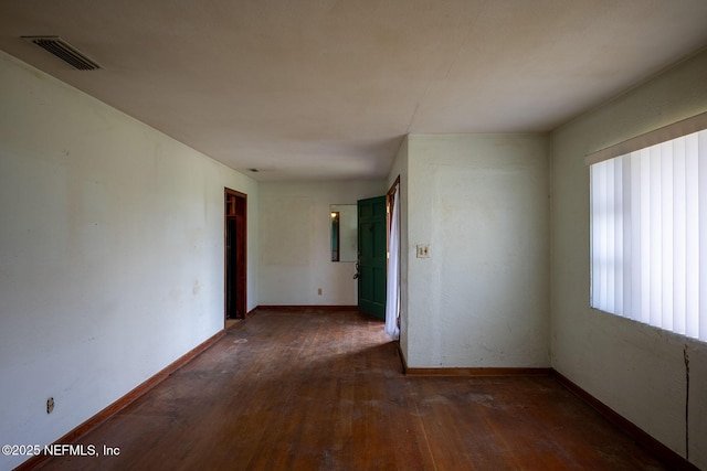 spare room with dark hardwood / wood-style flooring