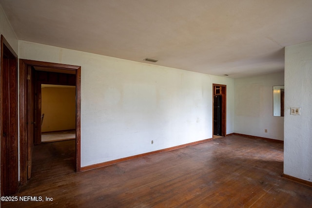 spare room featuring dark hardwood / wood-style flooring