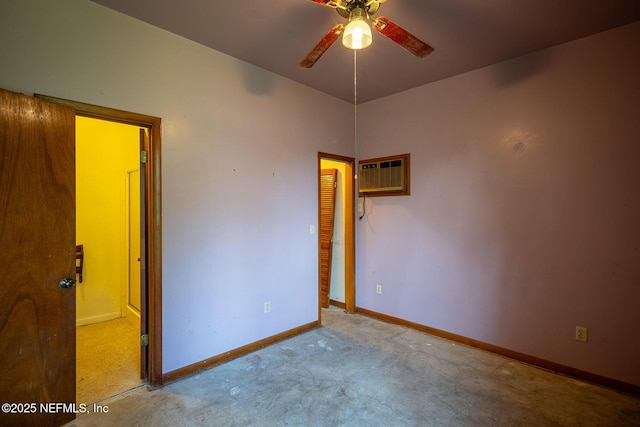 unfurnished room featuring a wall unit AC and ceiling fan