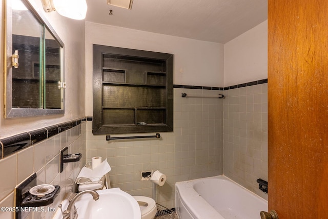 bathroom featuring tile walls, sink, and a bathing tub