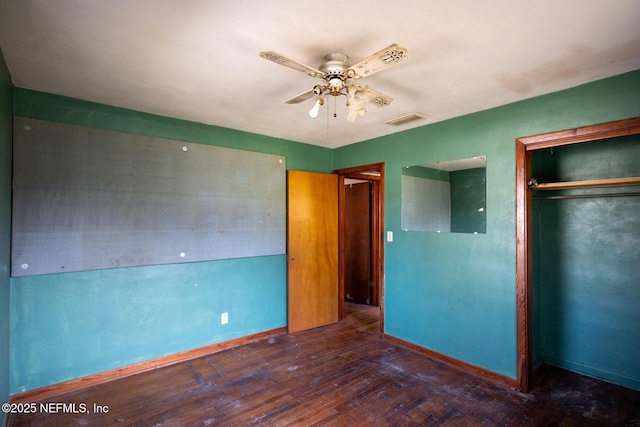 unfurnished bedroom featuring dark hardwood / wood-style flooring, a closet, and ceiling fan