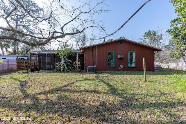 back of house featuring a yard and central air condition unit