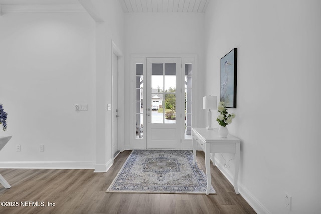 entryway with wood finished floors and baseboards