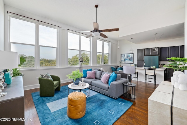 living room featuring dark wood-type flooring and ceiling fan