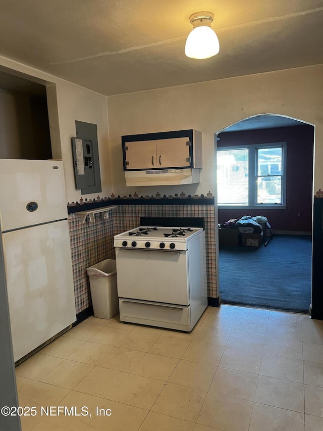 kitchen featuring light colored carpet, electric panel, and white appliances